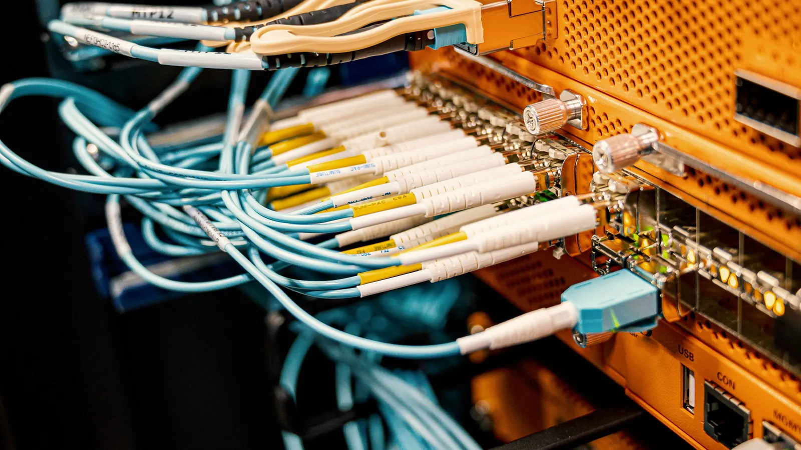 A structured cabling patch panel with network cables running in neat parallel rows