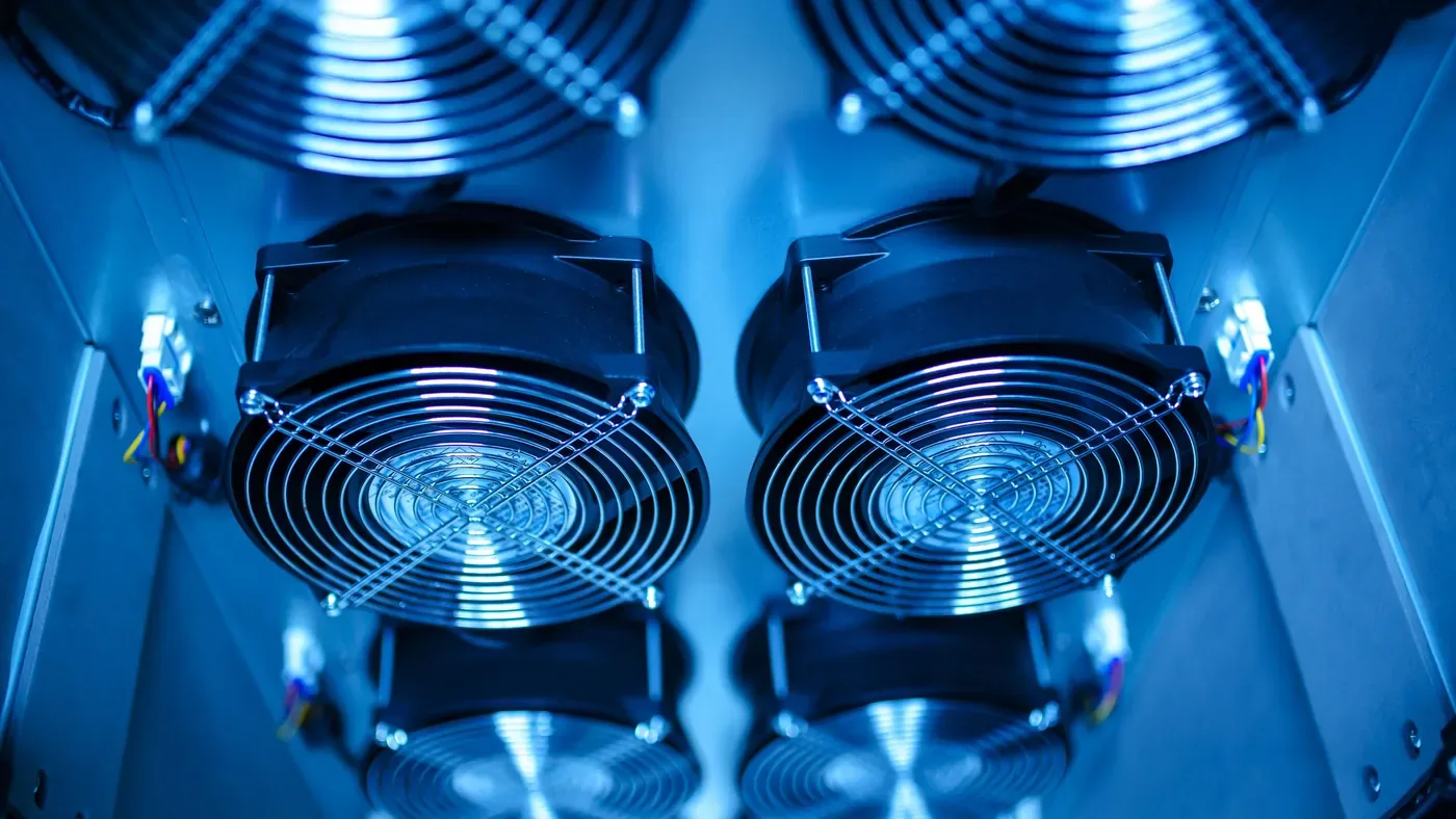 Rows of cooling fans lit in blue inside a server enclosure