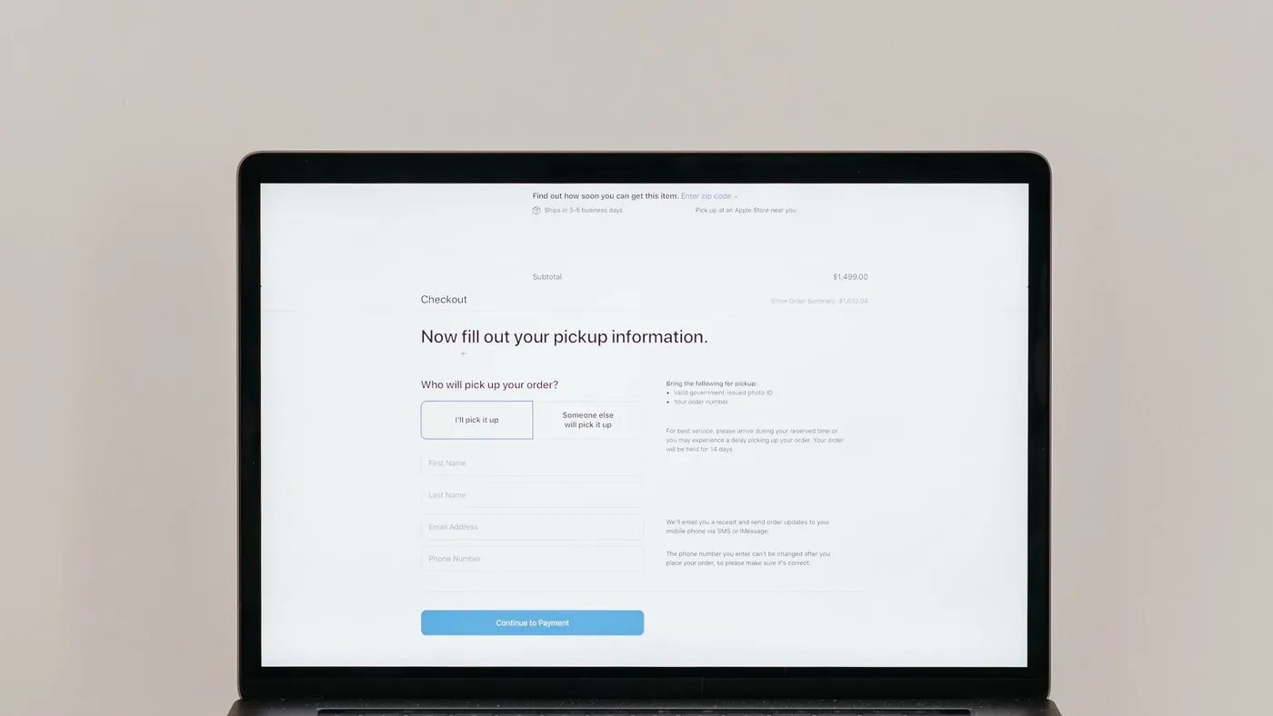 A laptop on a desk showing a plain online checkout form