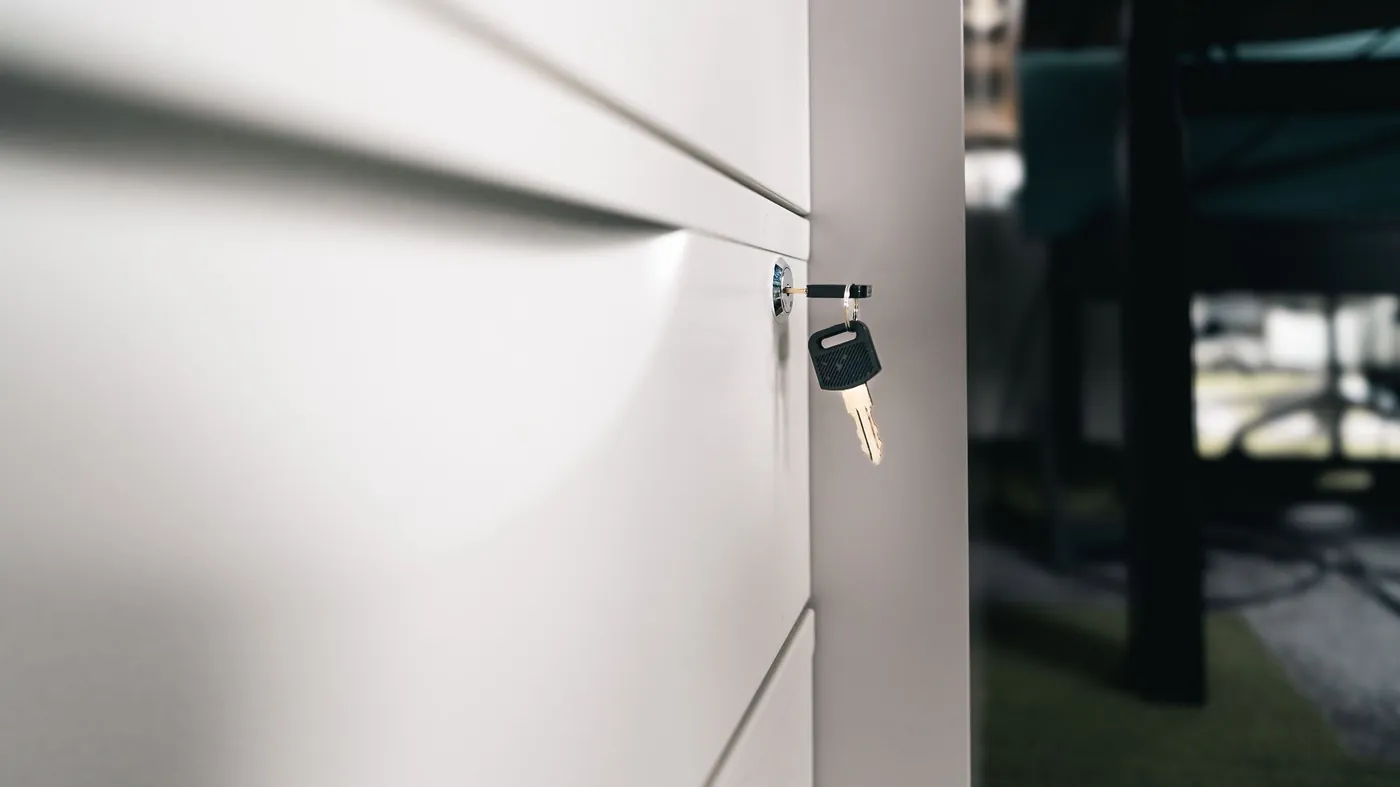 A key left in the lock of a secure office drawer